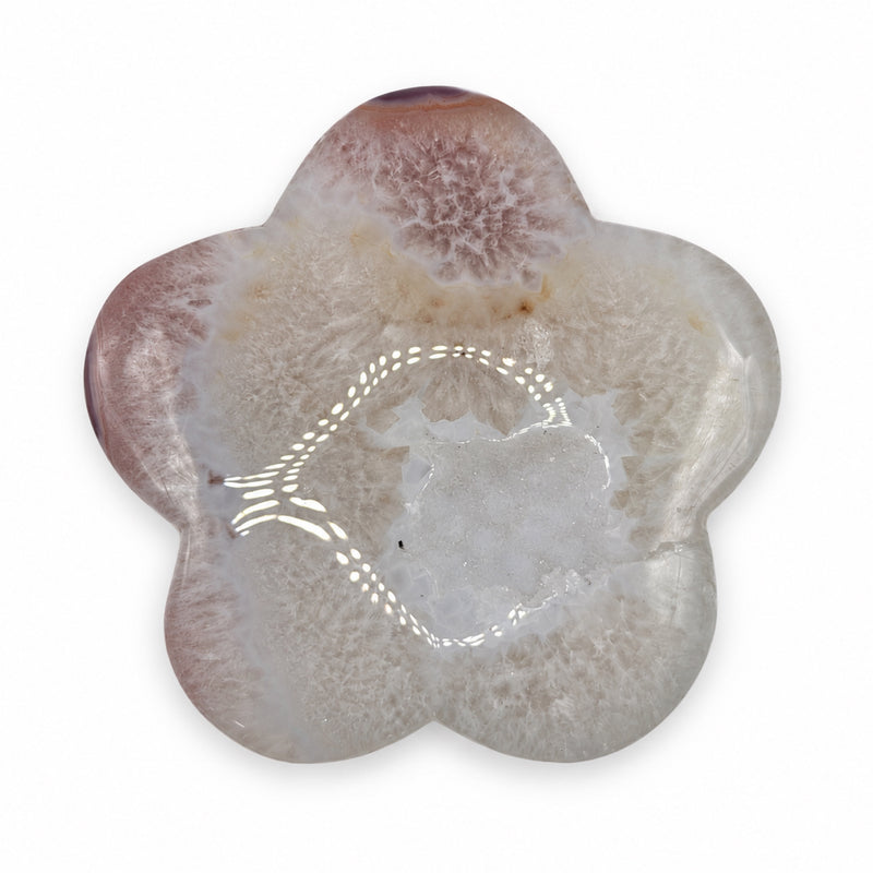 Pale five-petal flower-shaped stone with cloudy cream patterns, muted pink-brown edges, and a light crystalline center.