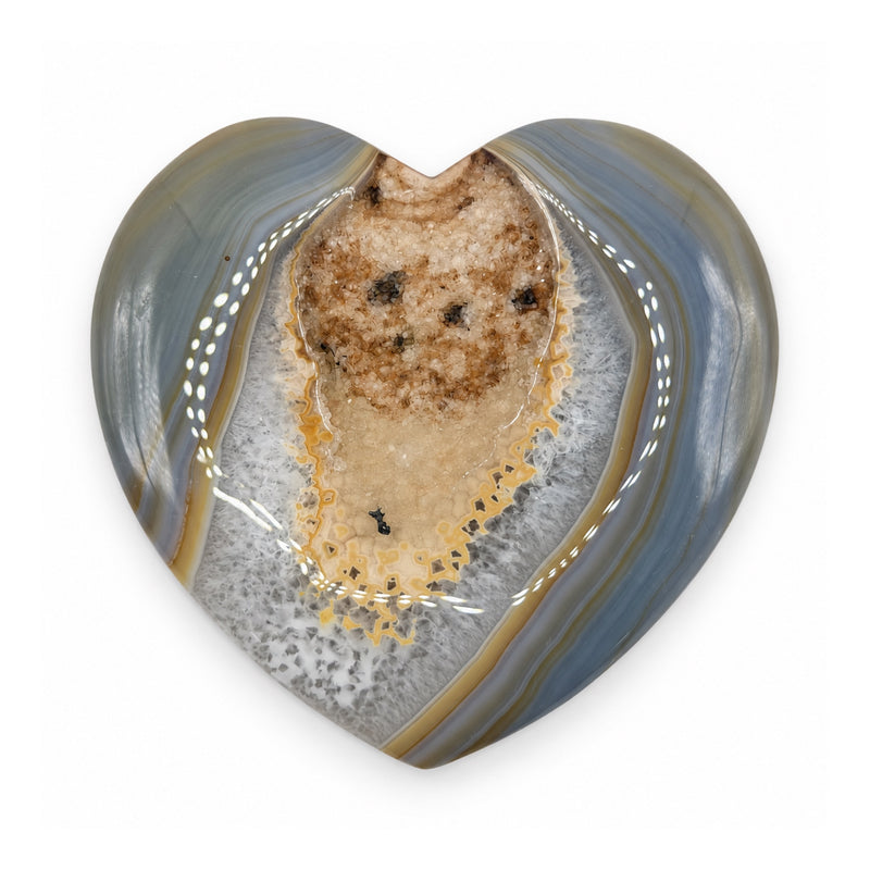 Front of a stone heart with a beige crystalline center, golden borders, and blue-gray bands.