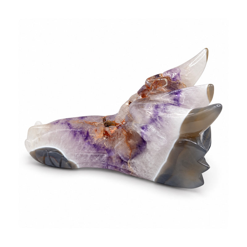Left profile of a white and lavender stone dragon skull with smoky horn tips, orange veins and dark carved nostril details.